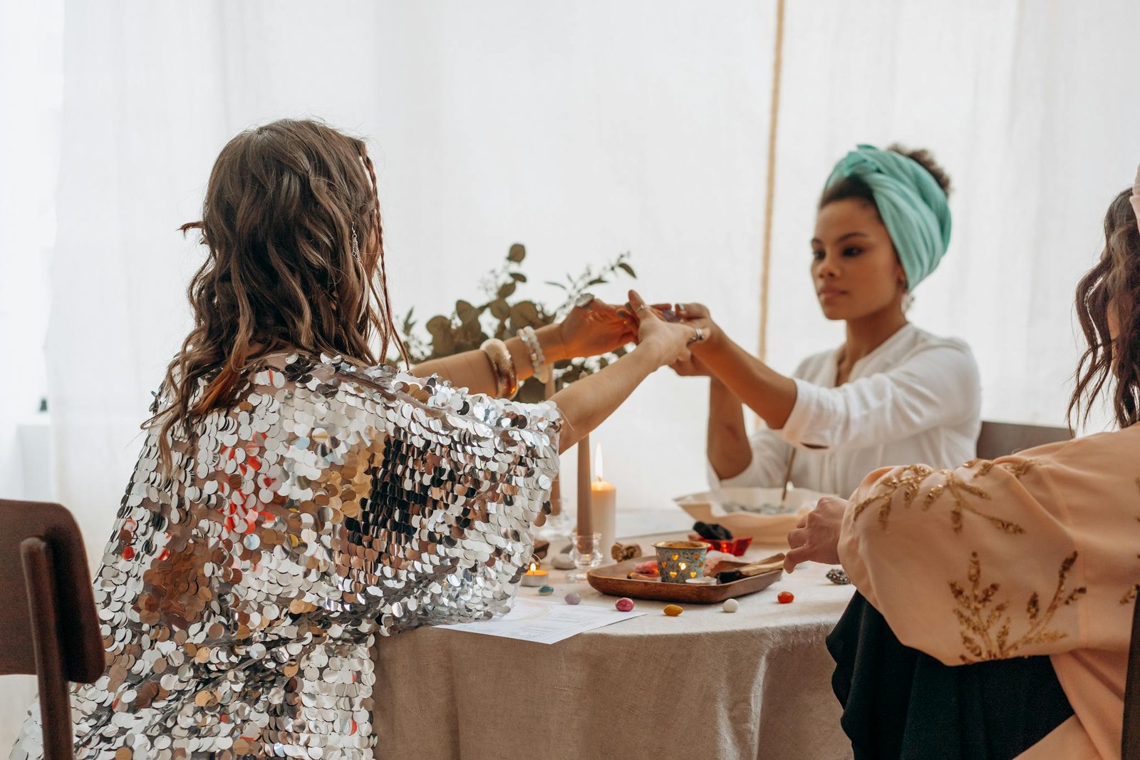 Three women practicing a spiritual ritual indoors, fostering connection and balance.